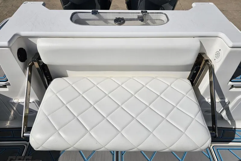 Slide: The Image of White cushioned seat on 2013 Sea Fox 286 Commander boat, featuring diamond stitching. - 112