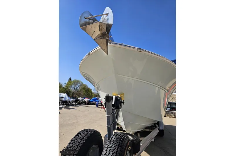 Slide: The Image of 2013 Sea Fox 286 Commander boat on trailer, featuring a prominent anchor, under clear blue sky. - 17