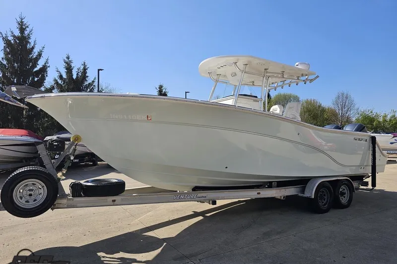 Slide: The Image of 2013 Sea Fox 286 Commander boat on trailer under clear blue sky. - 19