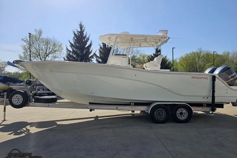 Slide: The Image of 2013 Sea Fox 286 Commander boat on trailer, parked outdoors. - 22