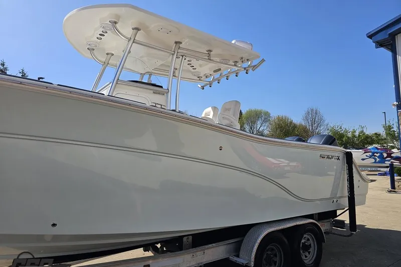Slide: The Image of 2013 Sea Fox 286 Commander boat on trailer under clear blue sky. - 23