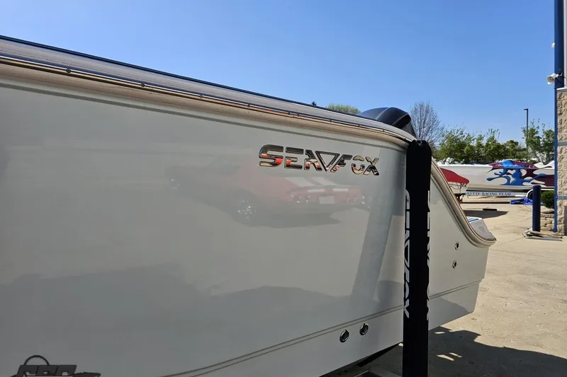 Slide: The Image of 2013 Sea Fox 286 Commander boat side view with logo in a sunny marina. - 24