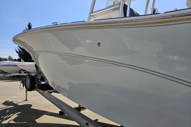 Slide: The Image of 2013 Sea Fox 286 Commander boat on trailer, side view under clear sky. - 25