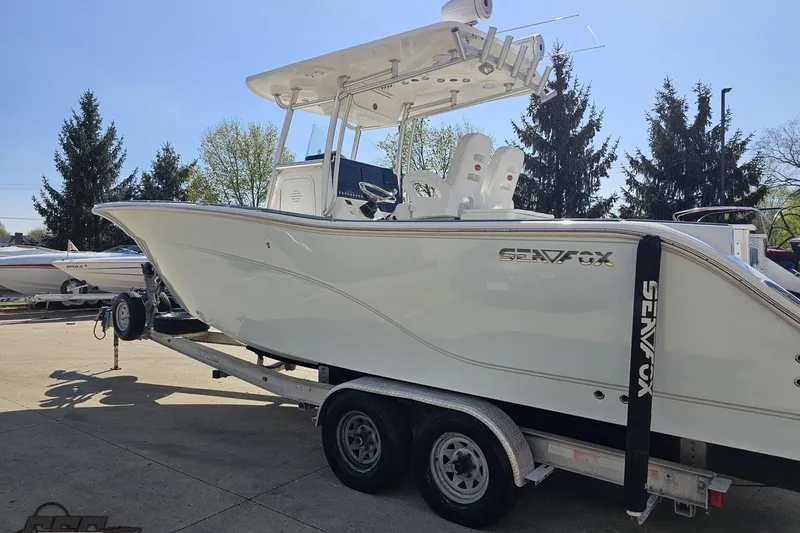Slide: The Image of 2013 Sea Fox 286 Commander boat on trailer, parked outdoors. - 27