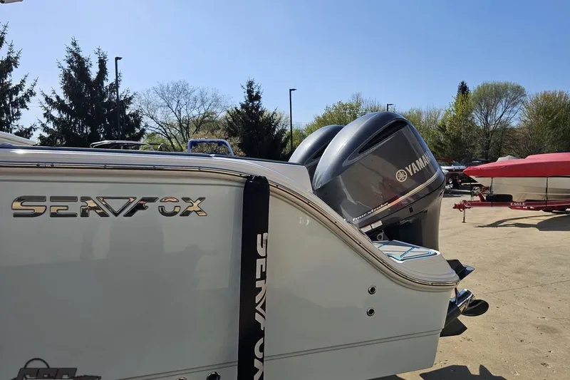 Slide: The Image of 2013 Sea Fox 286 Commander boat with Yamaha engines, parked outdoors. - 28