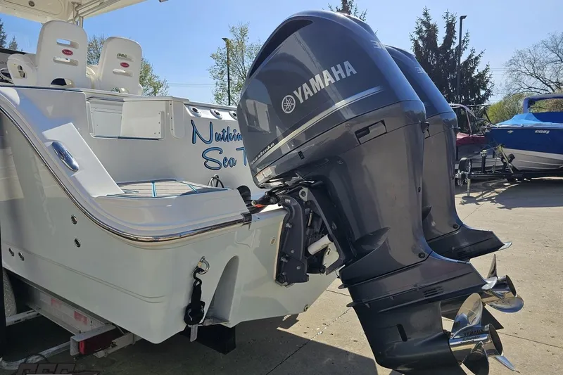 Slide: The Image of 2013 Sea Fox 286 Commander boat with Yamaha outboard engines, parked outdoors. - 30