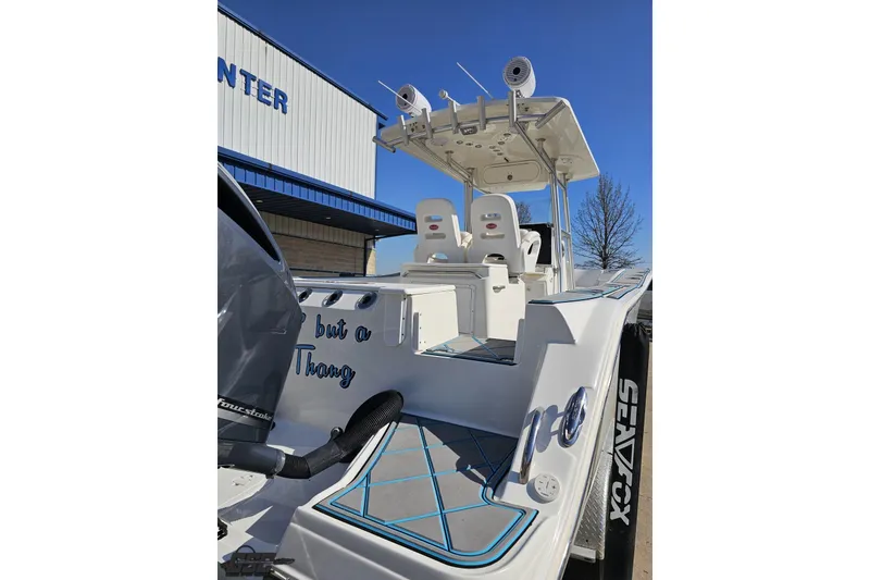 Slide: The Image of 2013 Sea Fox 286 Commander boat with dual seats and sleek design under clear blue sky. - 37