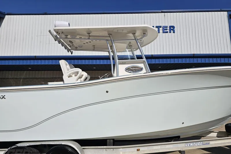 Slide: The Image of 2013 Sea Fox 286 Commander boat on trailer, side view with T-top and seating. - 4