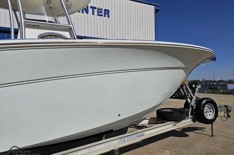 Slide: The Image of 2013 Sea Fox 286 Commander boat on trailer, parked outdoors under clear blue sky. - 5
