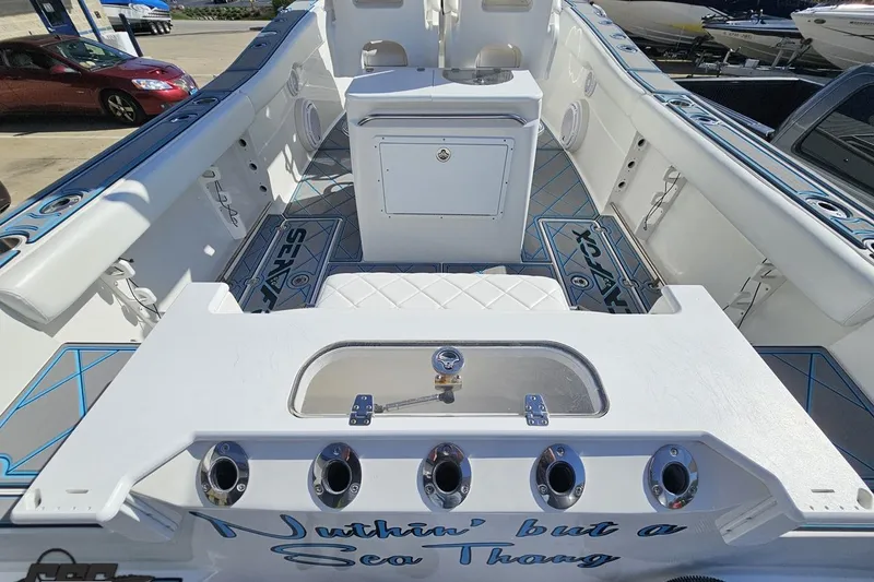 Slide: The Image of 2013 Sea Fox 286 Commander boat interior with fishing rod holders and storage compartments. - 51
