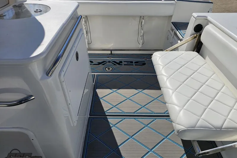 Slide: The Image of 2013 Sea Fox 286 Commander boat interior with cushioned seating and stylish flooring. - 55