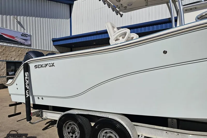 Slide: The Image of 2013 Sea Fox 286 Commander boat on trailer outside a building. - 6