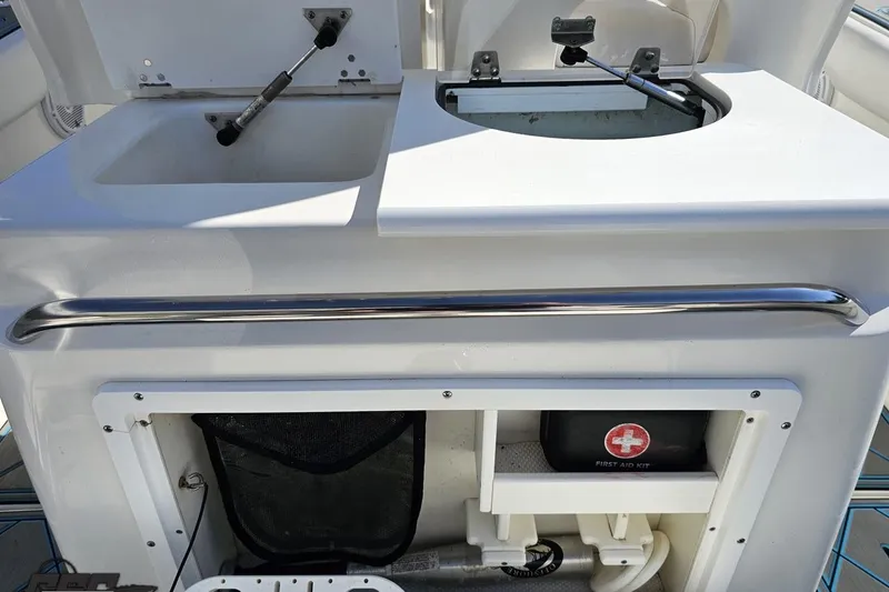 Slide: The Image of 2013 Sea Fox 286 Commander boat interior with storage compartments and first aid kit. - 61