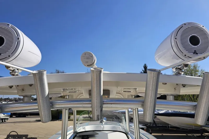 Slide: The Image of 2013 Sea Fox 286 Commander boat speakers and rod holders under clear blue sky. - 63