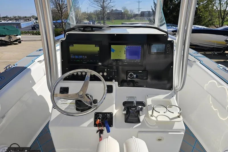 Slide: The Image of 2013 Sea Fox 286 Commander boat dashboard with steering wheel and navigation screens. - 65