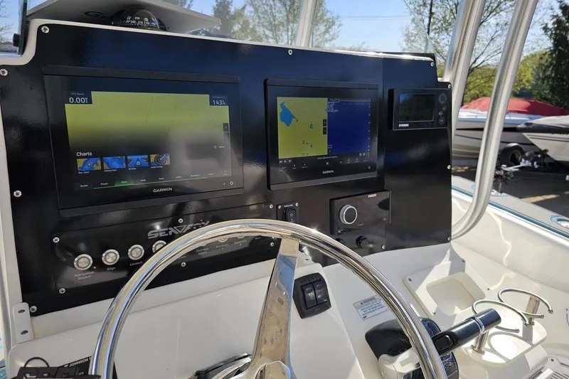 Slide: The Image of 2013 Sea Fox 286 Commander dashboard with Garmin navigation displays and steering wheel. - 70