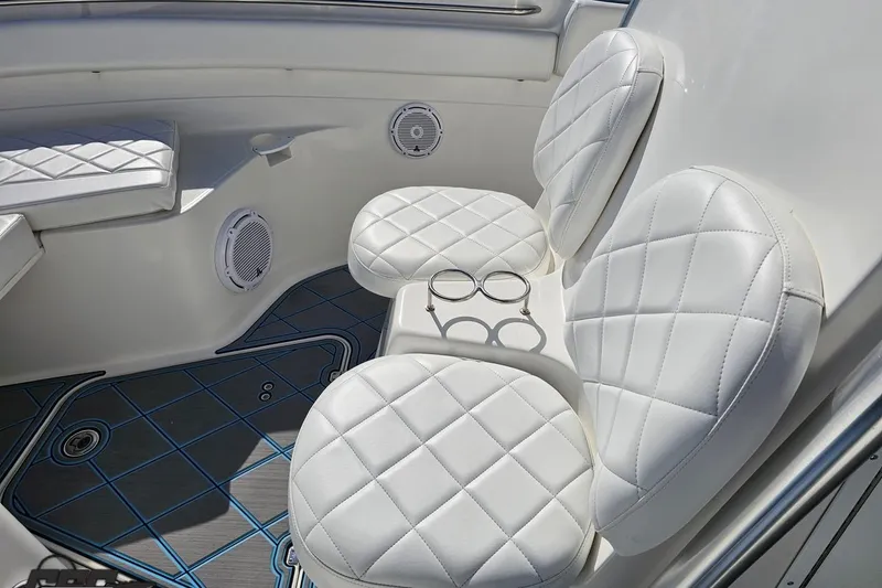 Slide: The Image of Interior of 2013 Sea Fox 286 Commander with white quilted seating and cup holders. - 78