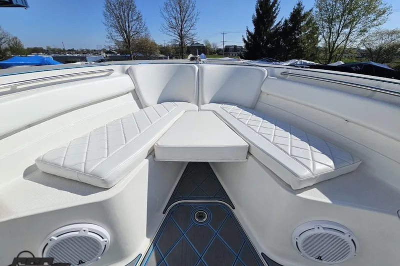 Slide: The Image of 2013 Sea Fox 286 Commander boat interior with white cushioned seating and speakers. - 79