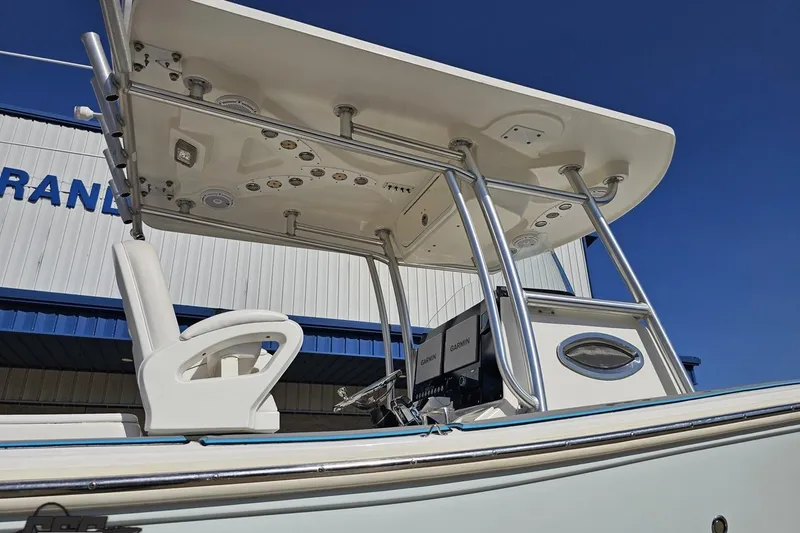 Slide: The Image of 2013 Sea Fox 286 Commander boat with T-top and Garmin electronics against blue sky. - 8