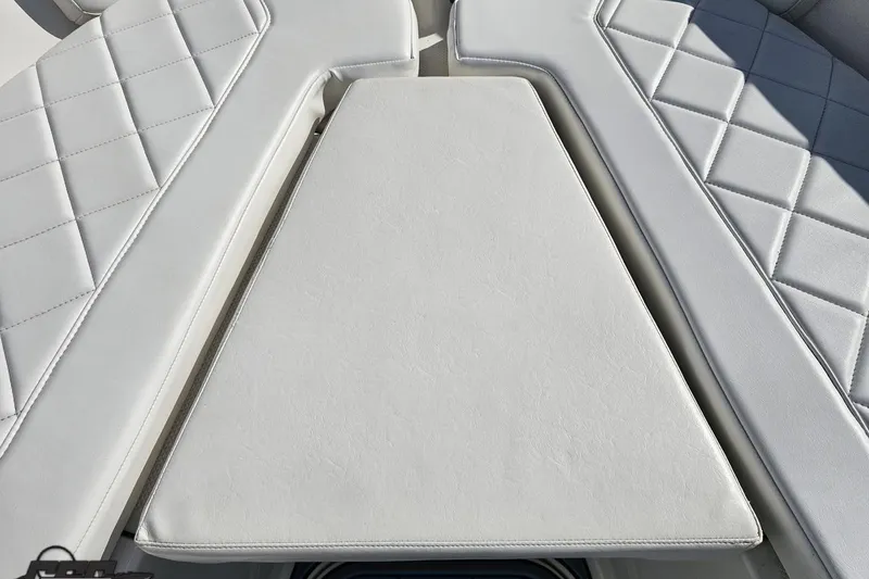 Slide: The Image of White cushioned seating on 2013 Sea Fox 286 Commander boat, featuring diamond stitching. - 81