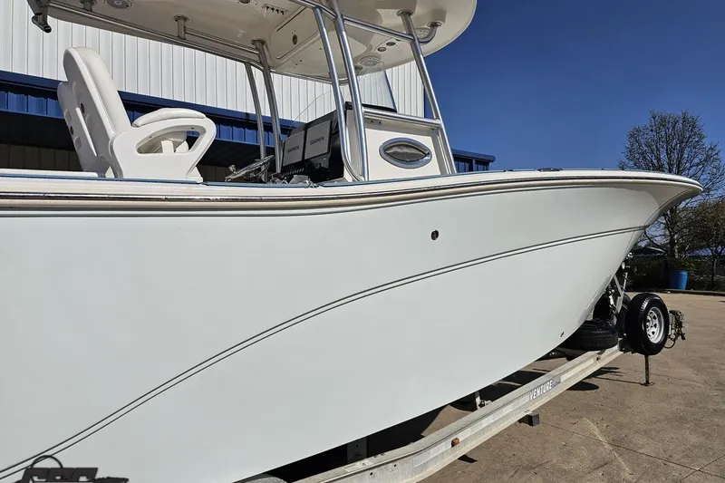Slide: The Image of 2013 Sea Fox 286 Commander boat on trailer, side view with clear sky background. - 9