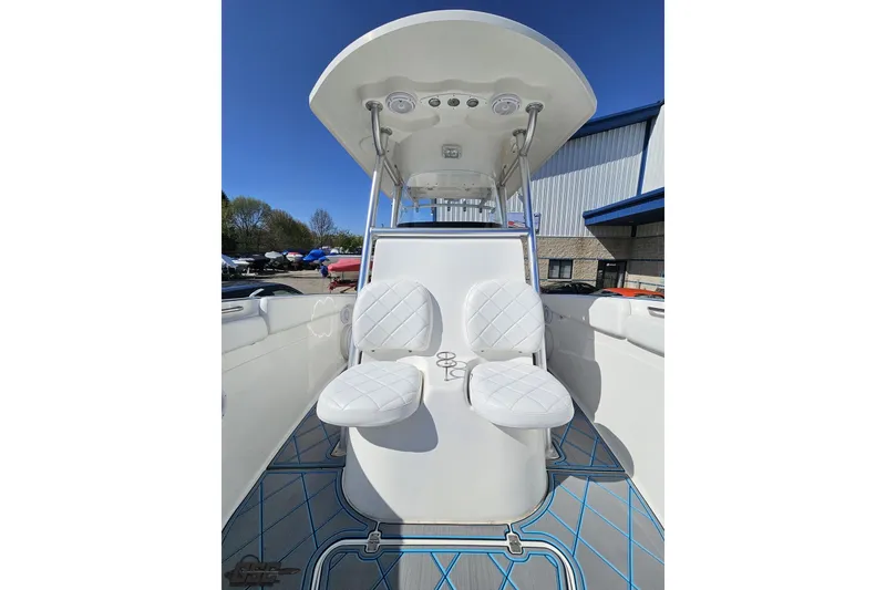 Slide: The Image of 2013 Sea Fox 286 Commander boat interior with white seating and blue accents. - 92
