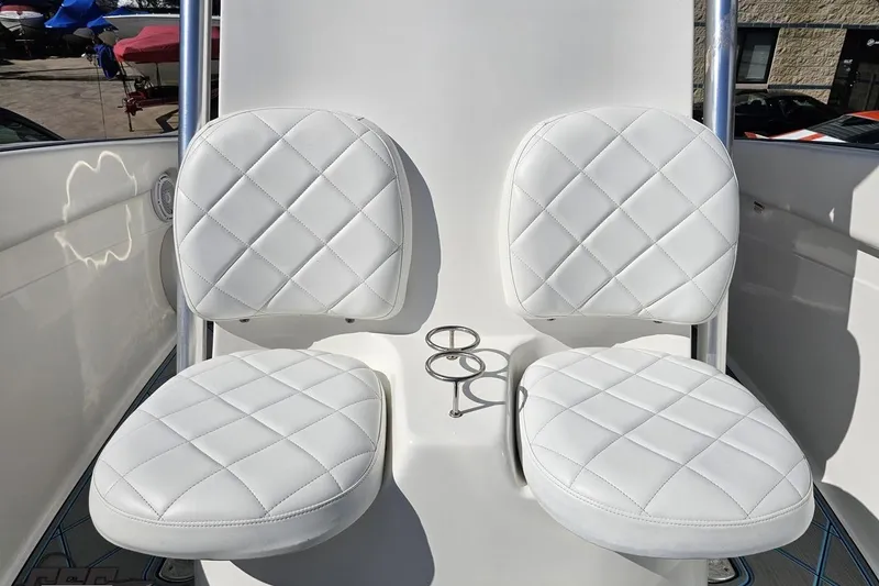 Slide: The Image of White cushioned seats on a 2013 Sea Fox 286 Commander boat, featuring diamond stitching. - 93