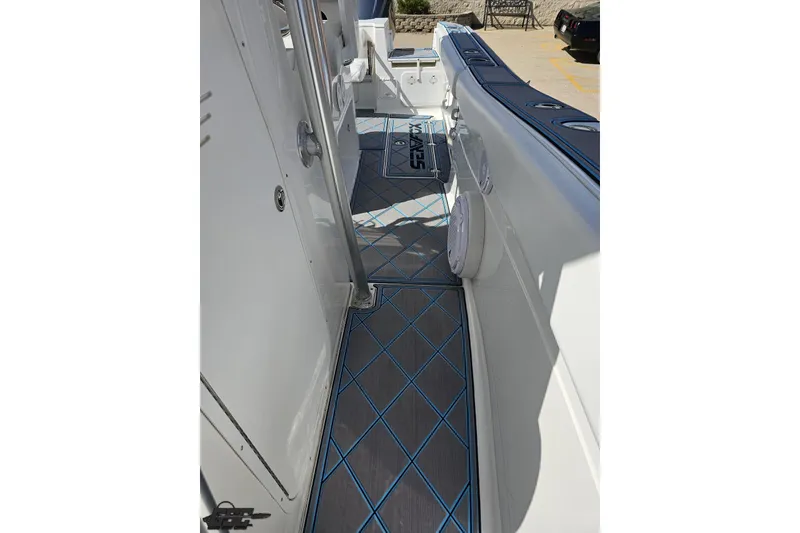 Slide: The Image of 2013 Sea Fox 286 Commander boat deck with blue diamond-patterned flooring. - 95