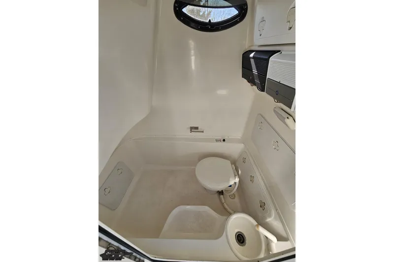 Slide: The Image of Interior of 2013 Sea Fox 286 Commander boat, featuring a compact marine toilet. - 97