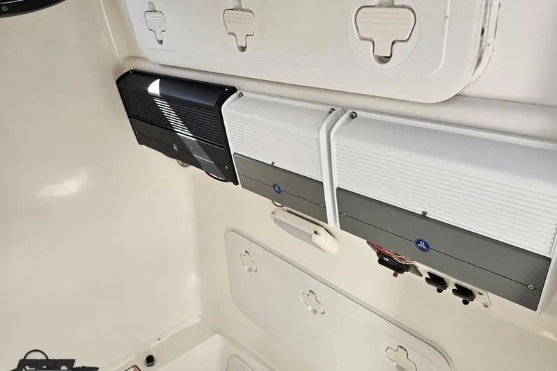 Slide: The Image of Electrical panel inside 2013 Sea Fox 286 Commander boat, featuring multiple components and outlets. - 98