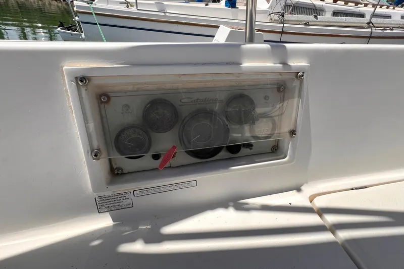 Slide: The Image of Instrument panel of a 1984 Catalina 30 sailboat, featuring gauges and controls. - 17