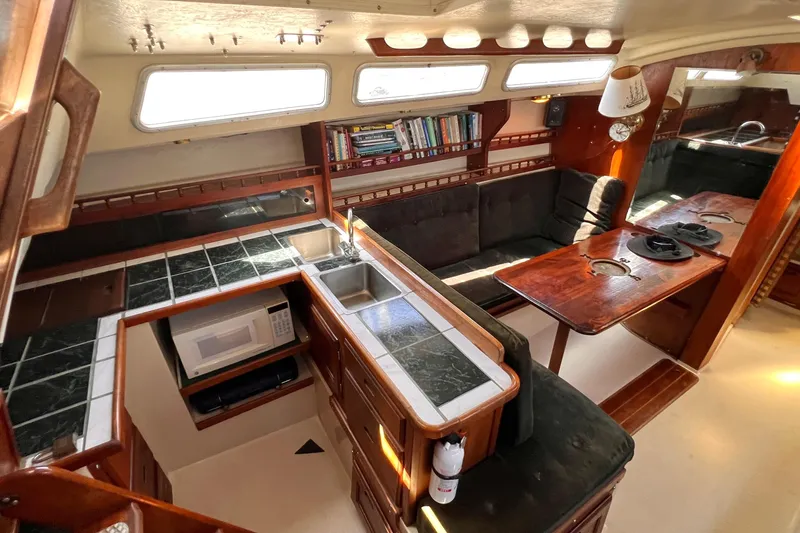 Slide: The Image of Interior of a 1984 Catalina 30 sailboat with kitchen and seating area. - 22
