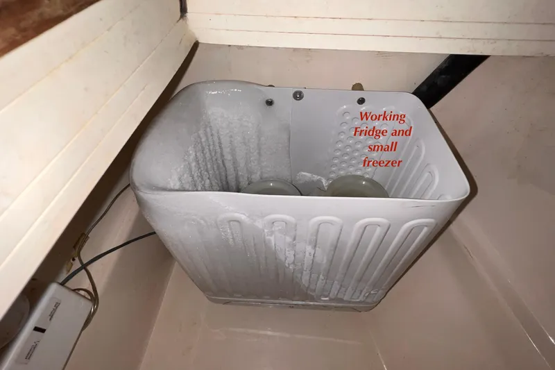 Slide: The Image of Small freezer inside a 1984 Catalina 30 boat, labeled "Working Fridge and Small Freezer." - 24