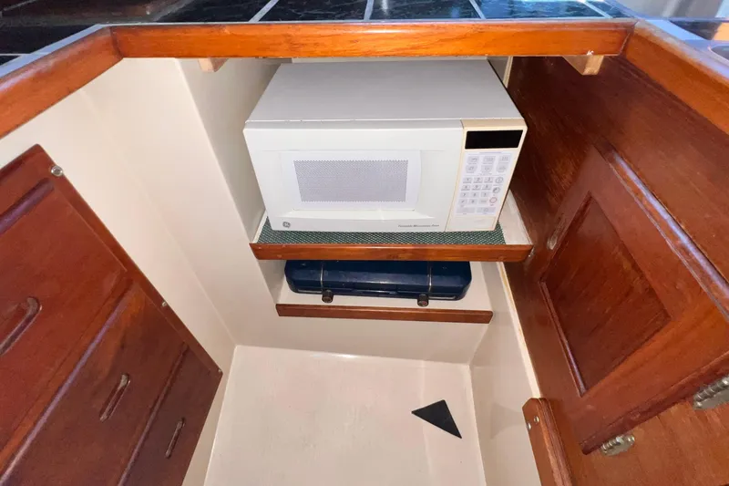 Slide: The Image of Microwave in 1984 Catalina 30 yacht kitchen with wooden cabinetry. - 25