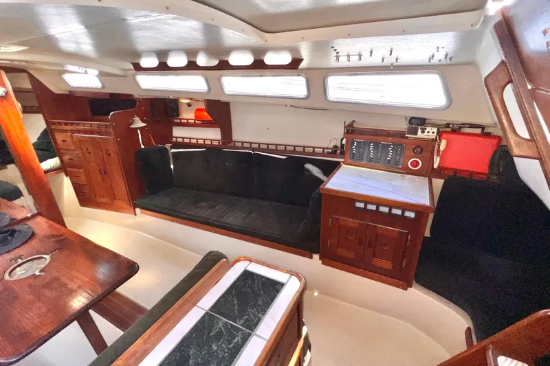Slide: The Image of Interior of a 1984 Catalina 30 sailboat with wood accents and navigation station. - 28