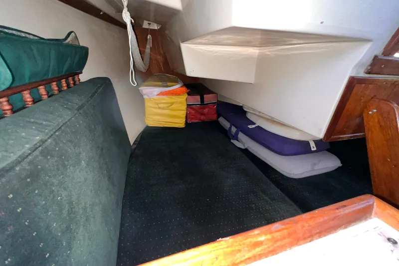Slide: The Image of Interior cabin of a 1984 Catalina 30 sailboat with cushions and storage bags. - 29
