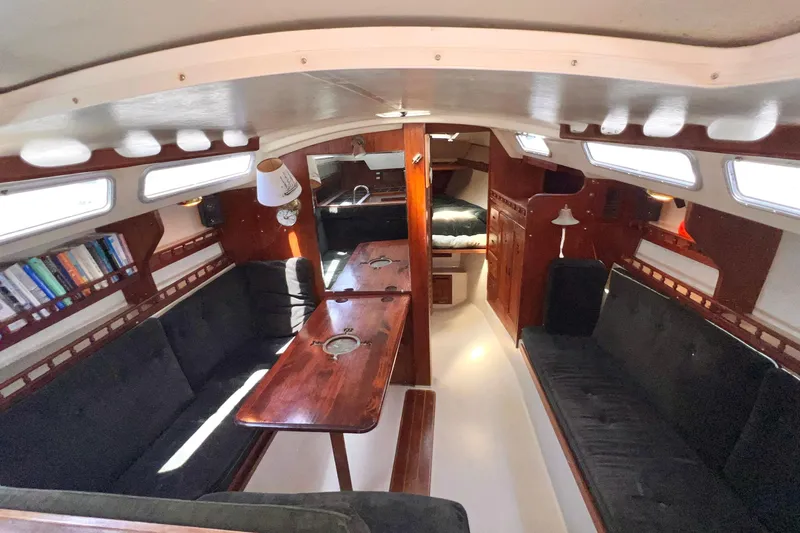 Slide: The Image of Interior of a 1984 Catalina 30 sailboat with cozy seating and wooden finishes. - 33