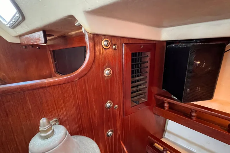 Slide: The Image of Interior of a 1984 Catalina 30 sailboat with wooden paneling and speaker. - 34