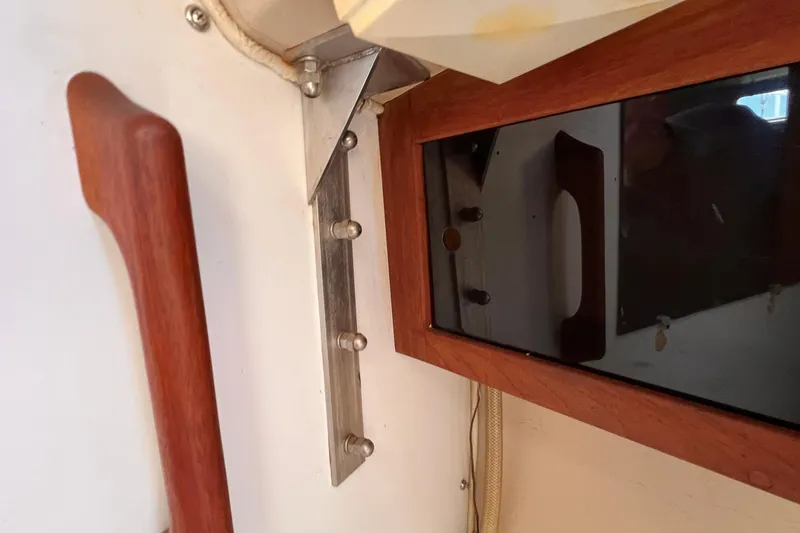 Slide: The Image of Interior detail of a 1984 Catalina 30 sailboat, featuring wood and metal fixtures. - 39