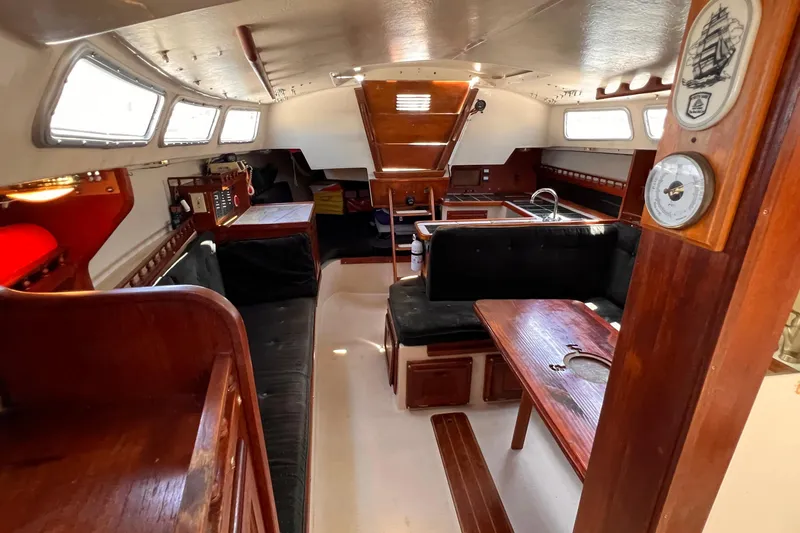 Slide: The Image of Interior of a 1984 Catalina 30 sailboat with wood furnishings and seating area. - 47