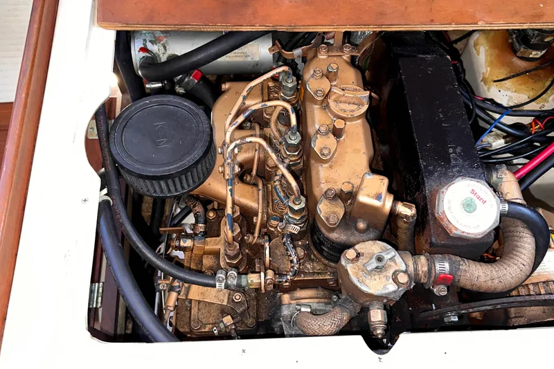 Slide: The Image of Engine compartment of a 1984 Catalina 30 sailboat, showcasing detailed mechanical components. - 48