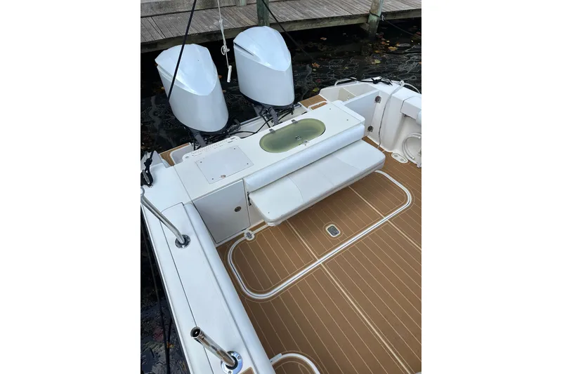 Slide: The Image of 2008 Pursuit OS 335 Offshore boat deck with twin engines and seating area. - 10