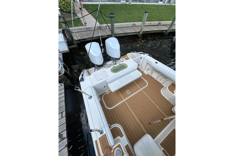 Slide: The Image of 2008 Pursuit OS 335 Offshore boat docked, featuring dual engines and spacious deck. - 11