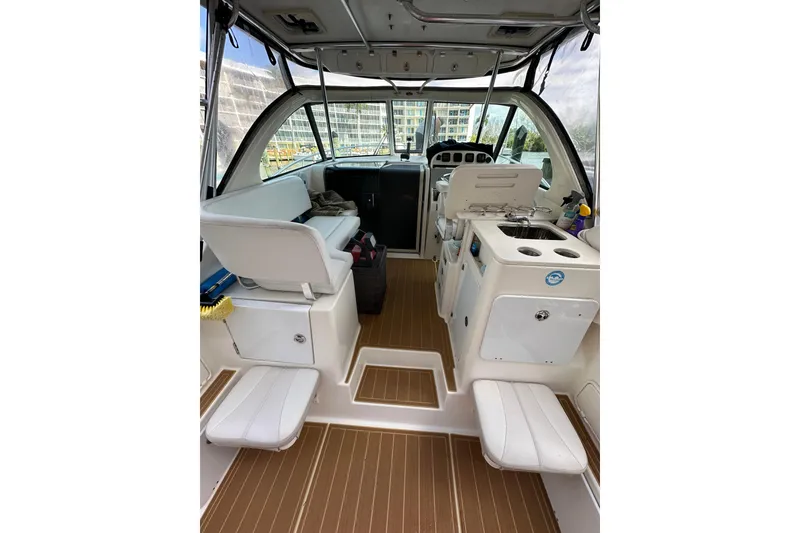 Slide: The Image of 2008 Pursuit OS 335 Offshore boat interior with seating and helm station. - 13