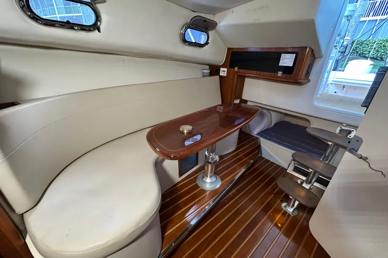 Slide: The Image of Interior of 2008 Pursuit OS 335 Offshore boat with seating and wooden table. - 26