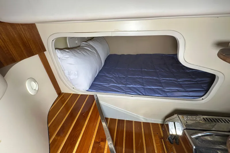 Slide: The Image of 2008 Pursuit OS 335 Offshore cabin with cozy bed and wooden flooring. - 28