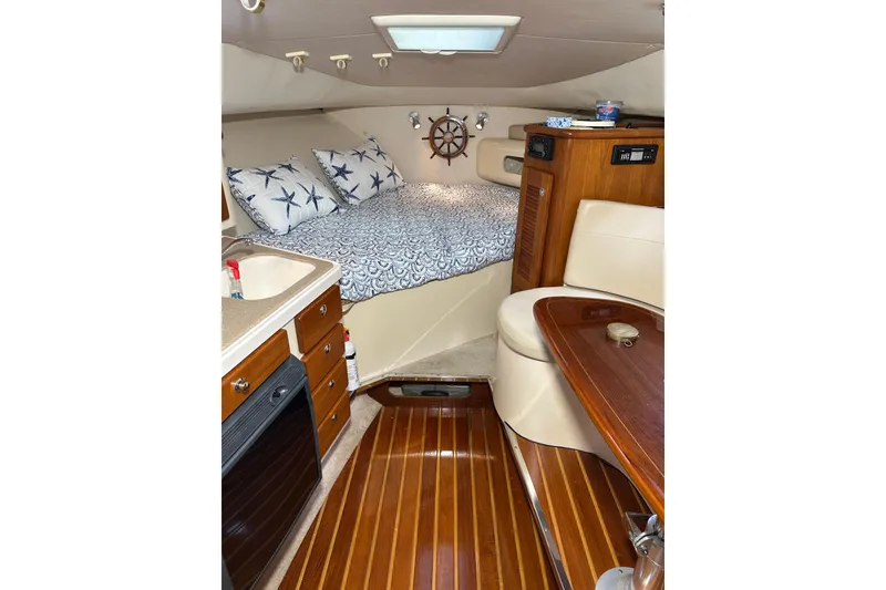 Slide: The Image of Interior of 2008 Pursuit OS 335 Offshore boat with cozy cabin and wooden finishes. - 30