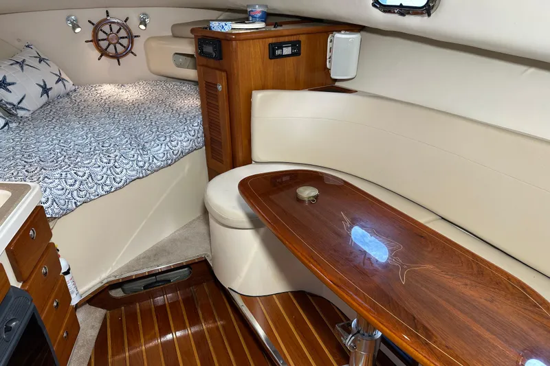 Slide: The Image of Interior of 2008 Pursuit OS 335 Offshore boat with cozy cabin and wooden table. - 31