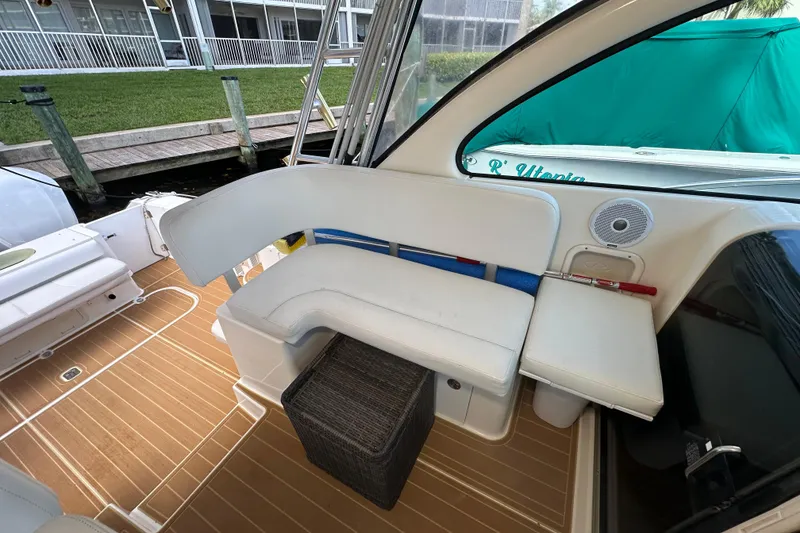 Slide: The Image of 2008 Pursuit OS 335 Offshore boat interior with white seating and teak flooring. - 37
