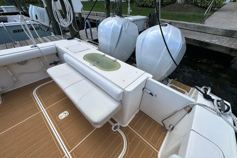 Slide: The Image of 2008 Pursuit OS 335 Offshore boat deck with seating and twin outboard engines. - 38